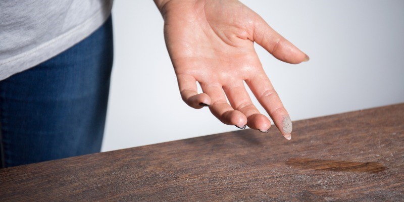 Dust on ladies finger, ran through dust on furniture