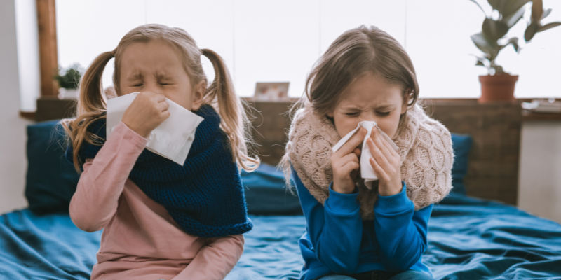 Two sisters both sick on bed - 8 Ways Your Humidifier Makes Living in Canada Easier